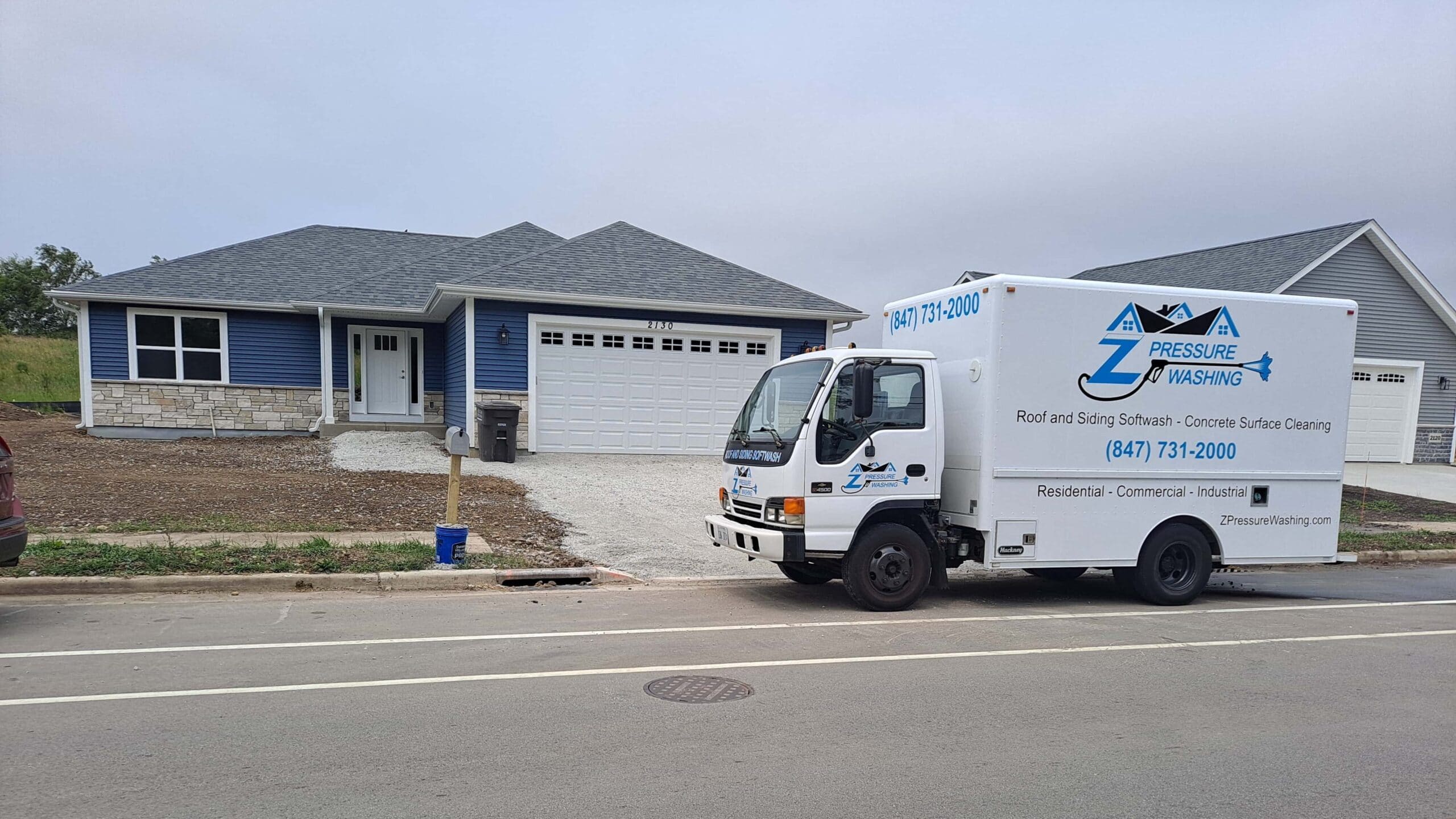 The Z Pressure Washing truck sitting in front of a freshly cleaned home.